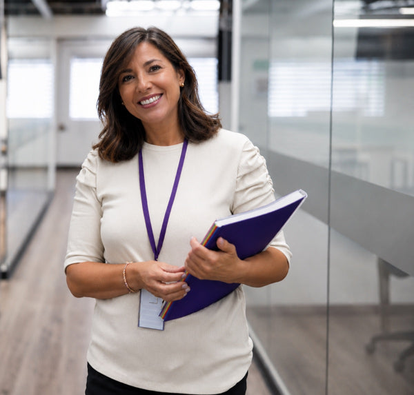 Career coaching professional holding a portfolio in a modern office