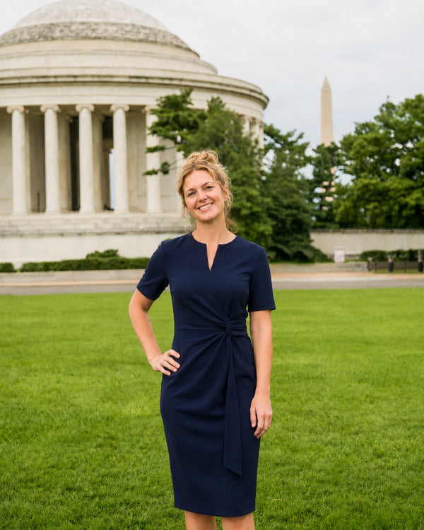 Professional in business attire near the Jefferson Memorial and Washington Monument in Washington, D.C.